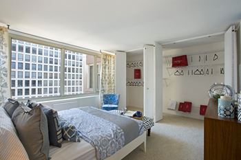 a bedroom with a bed and a large window